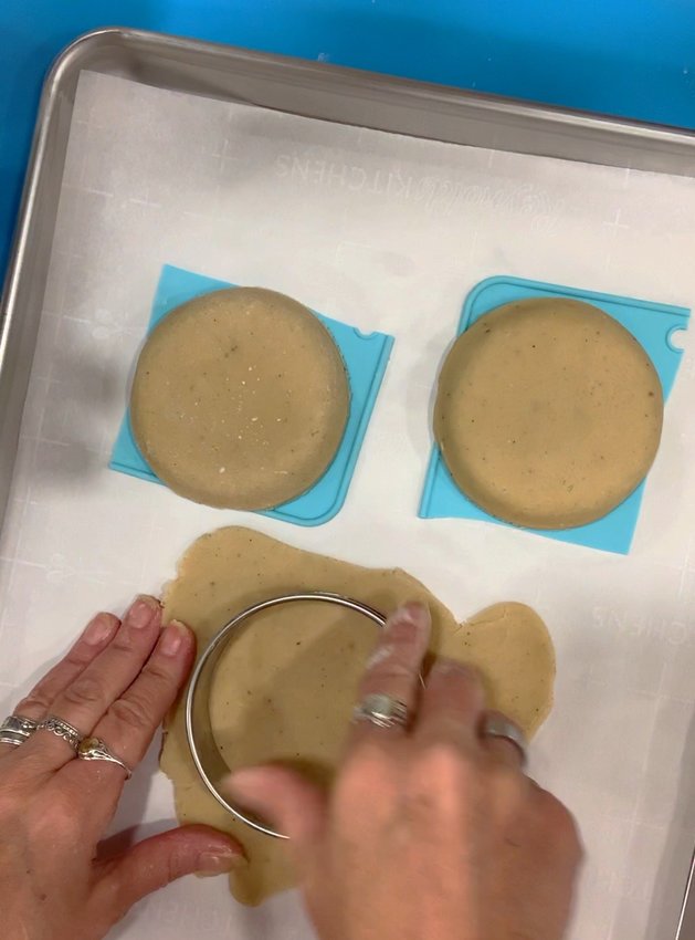 Roll out sugar cookie dough for bottom and trim dough to shape.